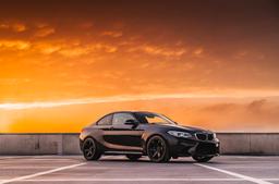 JR Wheels SL-03 Black alloy wheel mounted on car in an atmospheric setting