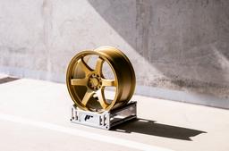 JR Wheels SL-03 Gold alloy wheel mounted on car in an atmospheric setting