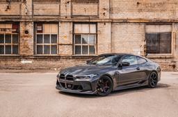 JR Wheels SL-03 Black alloy wheel mounted on car in an atmospheric setting