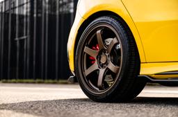 JR Wheels SL-03 Bronze alloy wheel mounted on car in an atmospheric setting