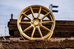 JR Wheels SL-04 Gold alloy wheel mounted on car in an atmospheric setting