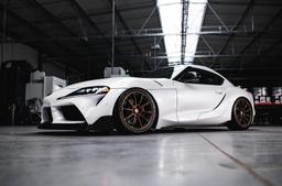 JR Wheels SL-04 Bronze alloy wheel mounted on car in an atmospheric setting