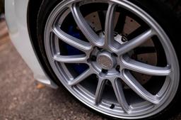 JR Wheels SL-04 Silver alloy wheel mounted on car in an atmospheric setting