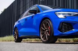 JR Wheels SL-04 Bronze alloy wheel mounted on car in an atmospheric setting