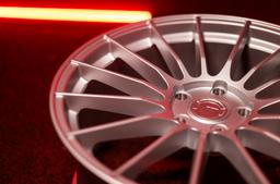 JR Wheels SL-05 Silver alloy wheel mounted on car in an atmospheric setting