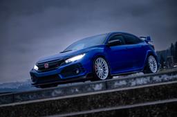 JR Wheels SL-05 Silver alloy wheel mounted on car in an atmospheric setting