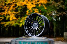 JR Wheels SL-05 Grey alloy wheel mounted on car in an atmospheric setting