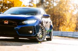 JR Wheels SL-05 Silver alloy wheel mounted on car in an atmospheric setting