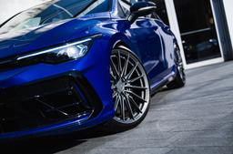 Vesser VSR4 Gloss Graphite alloy wheel mounted on car in an atmospheric setting